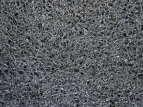 A close-up texture of a dark gray and black mesh or webbed material, filling the entire frame.